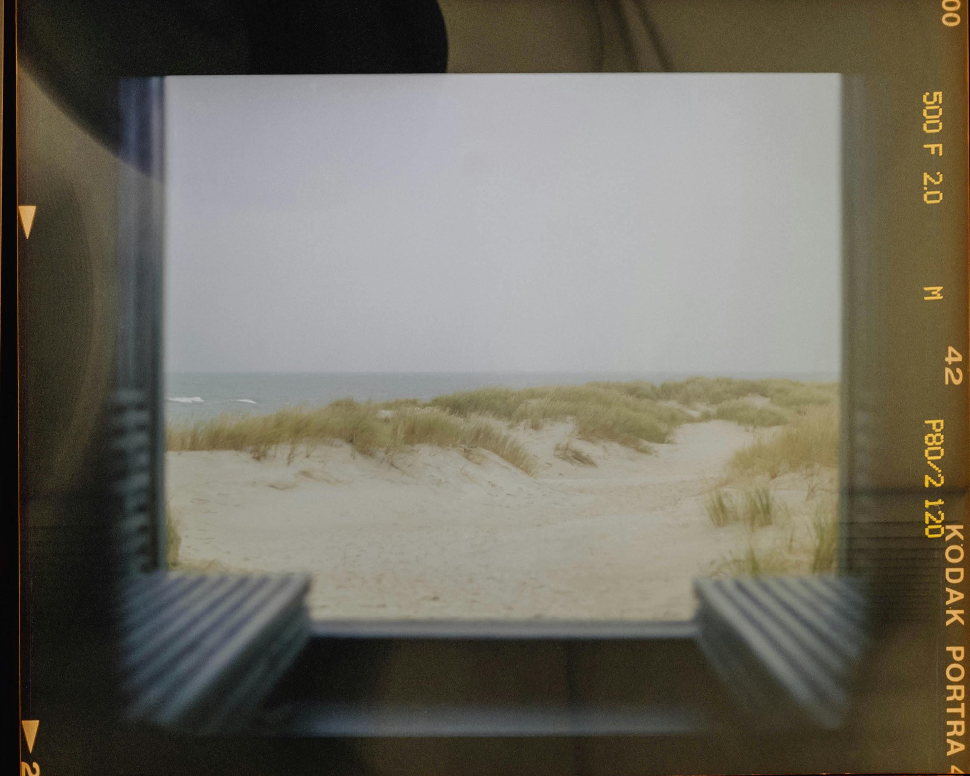 Film bordered view of quiet sand dunes