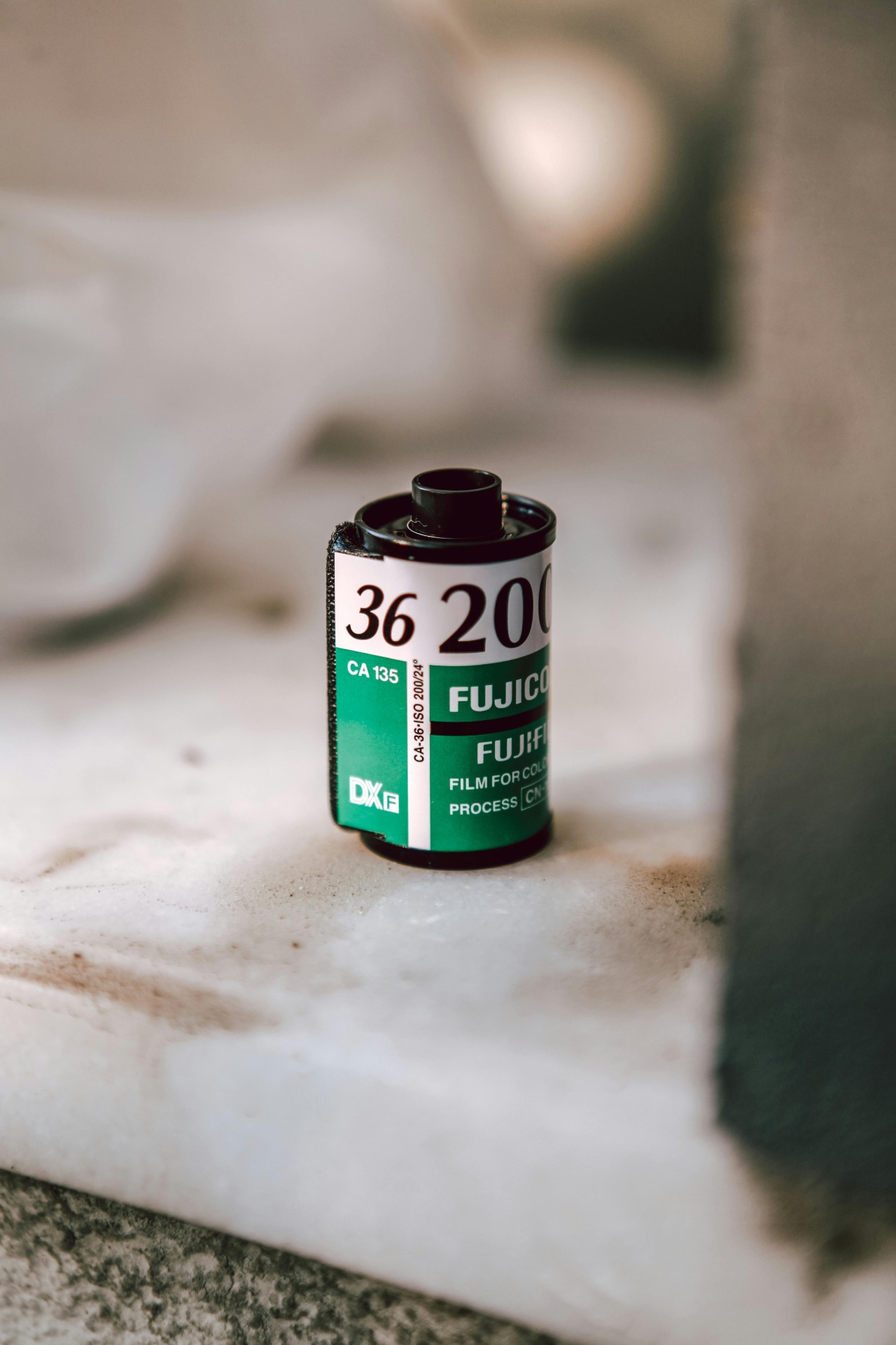 A close-up analog film roll on a marble surface